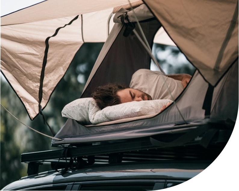 Camper Sleeping On Top Of His Car